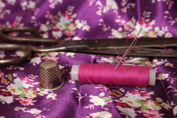 istock Hot Pink Thread on Vintage Pink and Purple Satin 2170016073