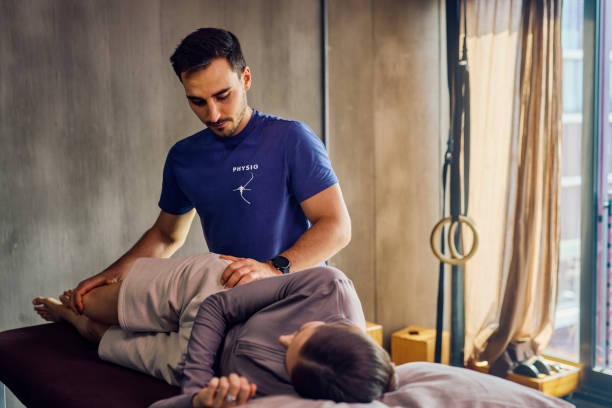 istock Physiotherapist examining patient's back during therapy session. Close-up shot in rehabilitation clinic. Healthcare and physical therapy concept. 2170016192