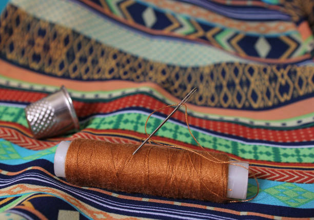 Threaded cotton through the eye of a needle