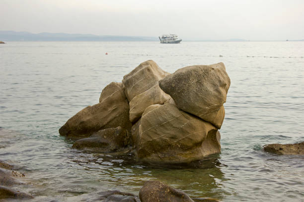 Landscape with large boulders in the sea. Sea beach with picturesque stones.