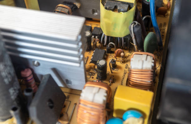 istock The power supply inductor is wrapped with a copper wire. Microchip resistors and electronic components with dust 2170019431