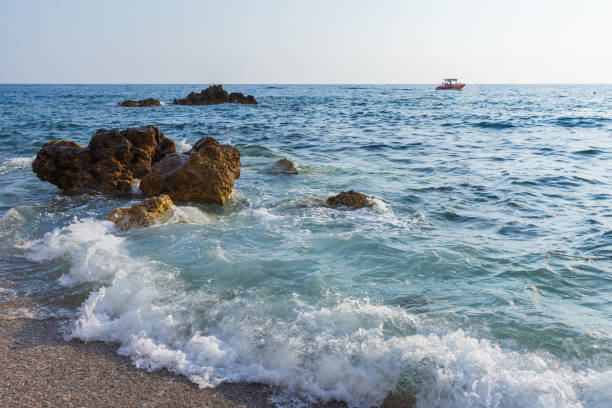 Landscape with shore waves and coastal rocks. Kargicak beach view, Turkey