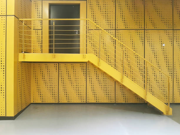 Yellow metal designer staircase. Close-up
