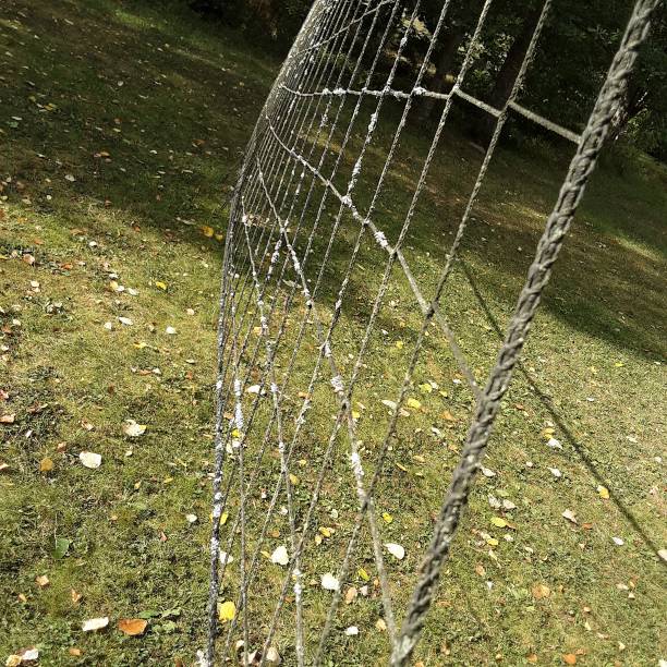 istock Old volleyball net and lawn with autumn leaves 2170022775