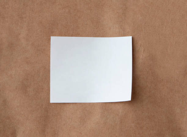 A blank square label featuring a red and blue border placed on a kraft paper background. The label offers ample space for custom text or designs, while the simple color scheme and clean lines provide a minimalist aesthetic.
