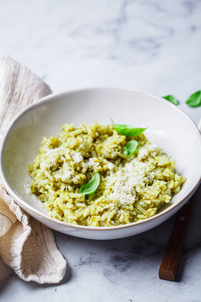 istock Green pesto risotto with parmesan, white background. 2170023533