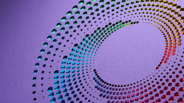 istock Vibrant spiral pattern with colorful cut-out circles on purple paper, forming a striking visual with precise geometric design and vivid color transitions. 2170023548