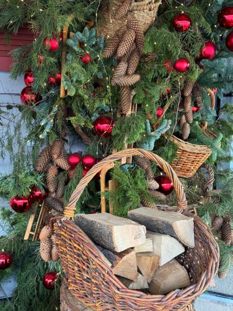 istock Christmas tree decorated with pine cones, red balls and basket with firewood 2170023719