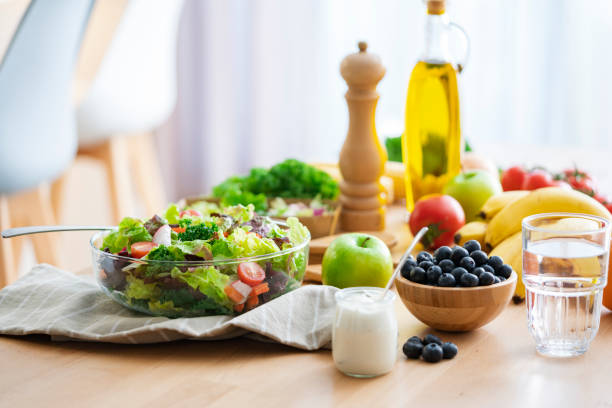 istock Dining table filled with a ealthy vegetables salad bowl and fruits 2170026600