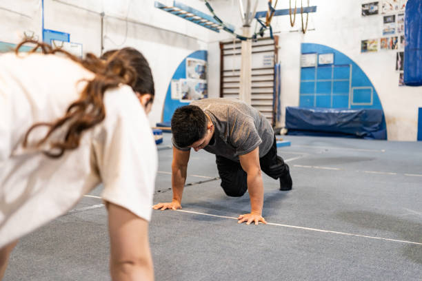 istock Friends doing abdominal exercises at the gym 2170029764