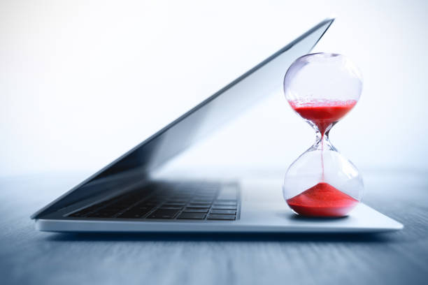istock Laptop with hourglass – Visualization of time management and deadlines 2170030188