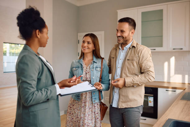 istock Happy couple communicating with their agent during real estate showing. 2170030509