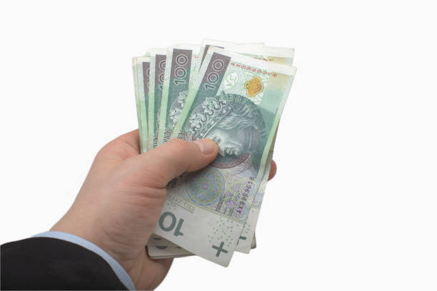 istock Hand Holding Stack of Polish 100 Zloty Banknotes 2170032012
