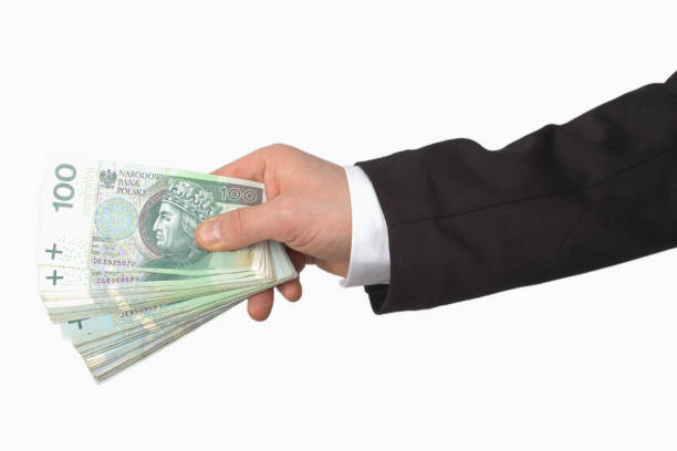 istock Hand Offering Polish 100 Zloty Banknotes 2170032123