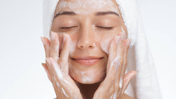 istock Serene Woman Gently Cleansing Face with Foaming Cleanser During Skincare Routine 2170032187