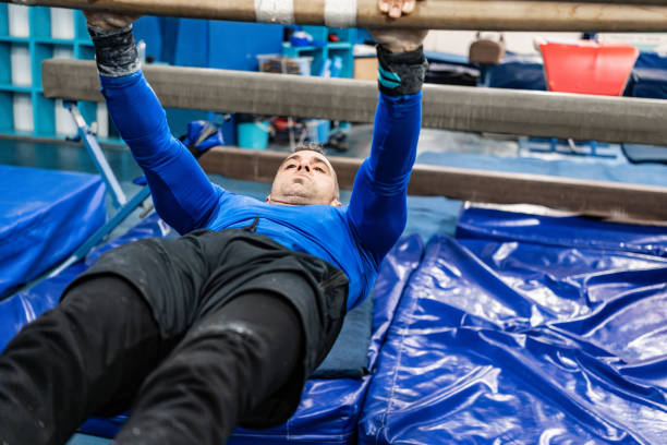 Mature man training on a parallel bars at the gym