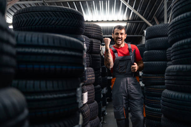 istock Working in warehouse sorting new car tires. 2170032999