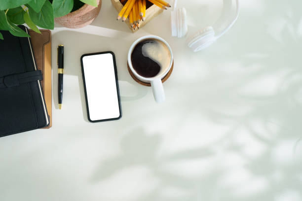 istock Top view smart phone with empty screen, notebook and coffee cup on office desk. Copy space for your text. 2170033112