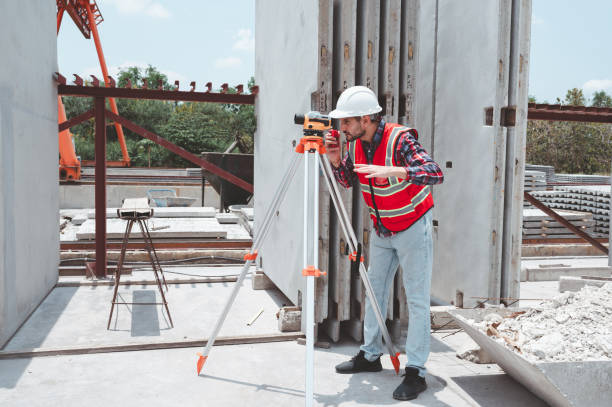 istock Engineer or worker construction architecture wear safety uniform and helmet with equipment theodolite to measurement positioning the building site is construction business concept. 2170033846
