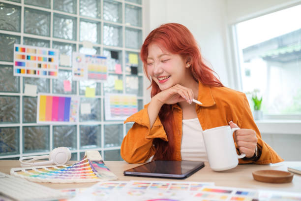 istock Cheerful graphic designer with long red hair is enjoying her work in a creative workspace. 2170033950