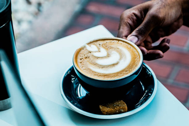 istock Close-up of hand holding coffee latte on mug 2170034533