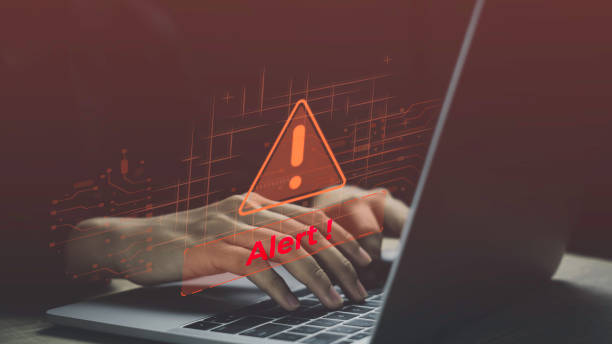 istock Cyber security alert with a focus on hacker threats and spyware. Warning message on laptop, Risks of scams, spam, and network security breaches. Caution in business and office environments. 2170035302