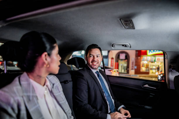 istock Coworkers talking inside a taxi 2170037259