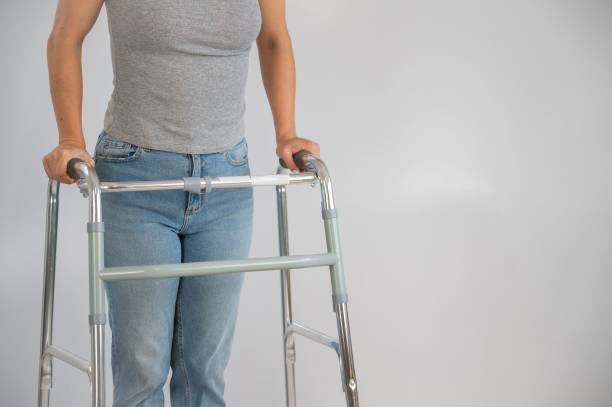 istock A woman is walking with a walker on a white background 2170038632