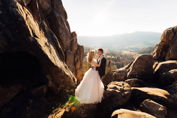 istock cliff overlooking the mountains. the newlyweds are hugging each 2170038665