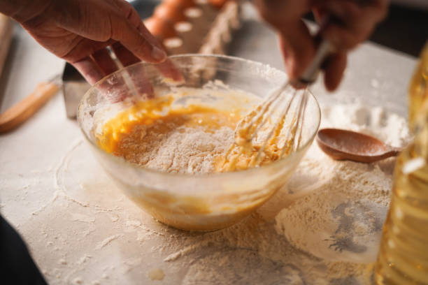 istock Baking preparation with flour and eggs being whisked in bowl by hand 2170041386