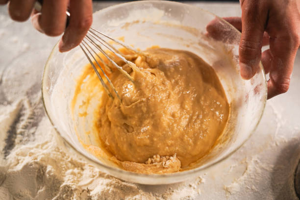 istock Pastry chef making dough with a whisk. cooking waffle on rustic wooden table with ingredients. Handmade dessert and cooking process 2170041392