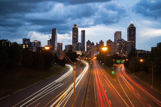 Atlanta, GA, USA: August 31,2024: Panoramic view of Atlanta skyline during sunset, long exposure with light trails short from Old Fourth ward in downtown Atlanta, USA