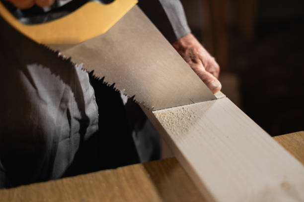 istock Handyman using hand saw. handyman with saw in workshop 2170044632