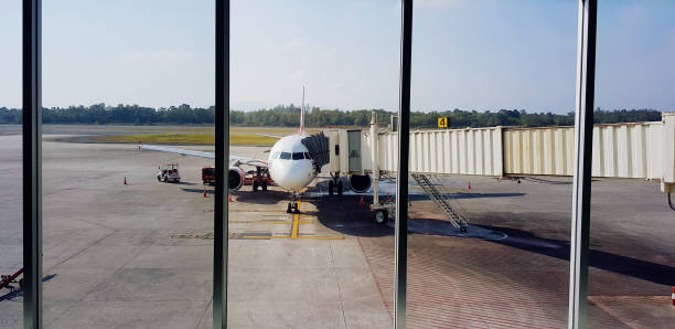 Songkhla, Thailand -July 22, 2024: Airplane parked and waiting for passenger get inside with blue sky and tree background at Hat Yai airport, Songkhla, Thailand. transportation and vehicle.