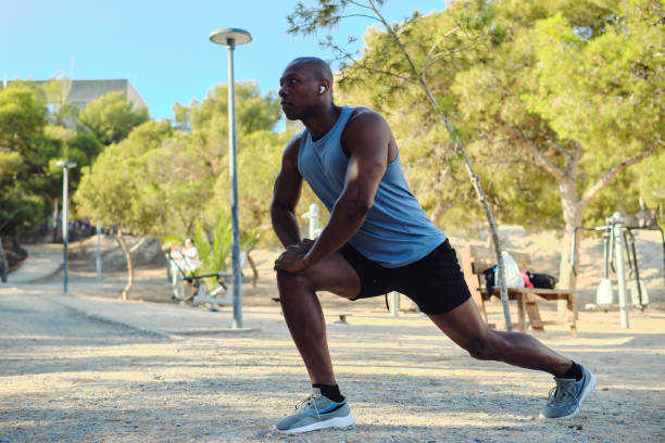 istock African athletic man do leg stretching exercises outdoors 2170047249