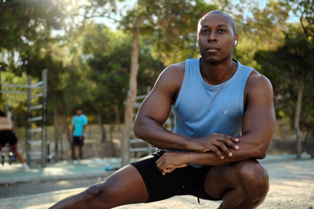 istock African athletic man do leg stretching exercises outdoors 2170047264