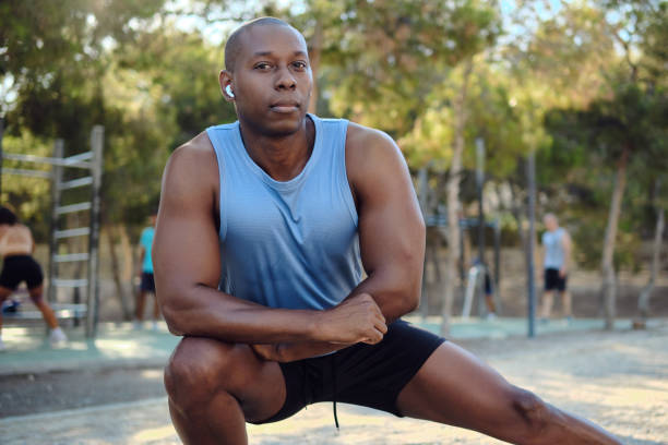istock African athletic man do leg stretching exercises outdoors 2170047462