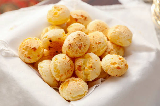 cheese bread served in a decorated basket on the table - Brazilian food - selective focus
