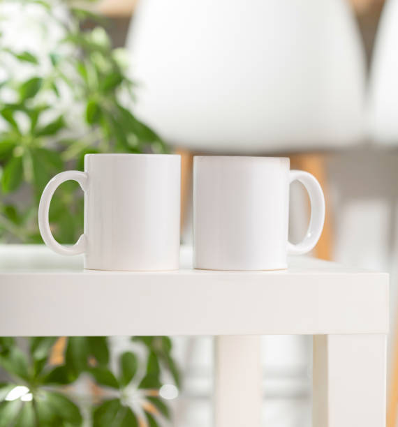 istock Mockup of a white tea cup or coffee mug on a white table in a Scandinavian style kitchen 2170050651
