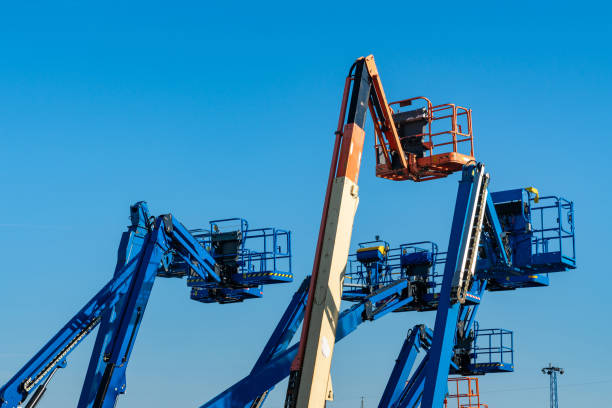 Cluster of boom lifts at a construction site.