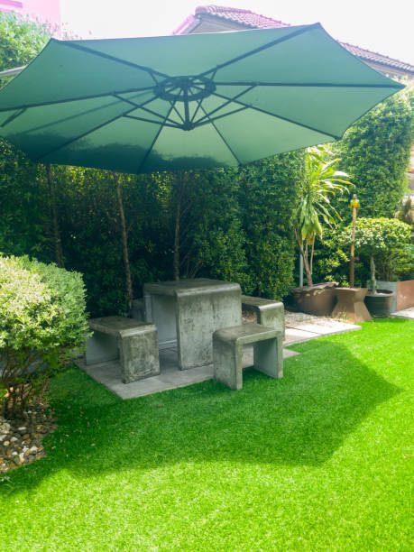 istock A green umbrella is over a patio table with two chairs 2170051312