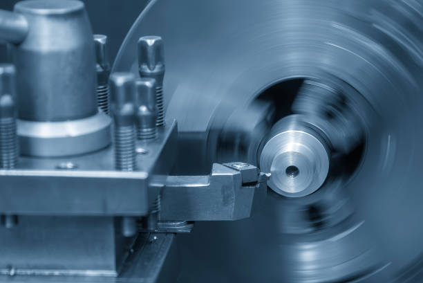 The turning machine operation with continue chip in the light blue scene. The metal working process on lathe machine.