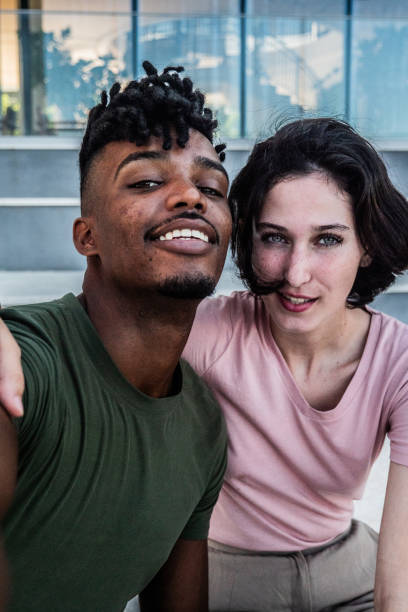 istock Young couple taking a selfie outdoors - Camera point of view 2170052446