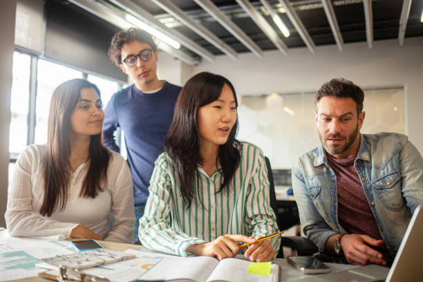 istock Young diverse group of professionals brainstorming at office 2170053052
