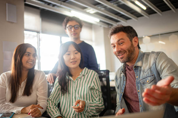 istock Young diverse group of professionals collaborating on new project 2170053068