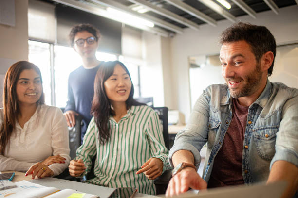 istock Young diverse group of professionals brainstorming at office 2170053079