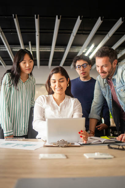 istock Small diverse group of young professionals collaborating on company project 2170053630