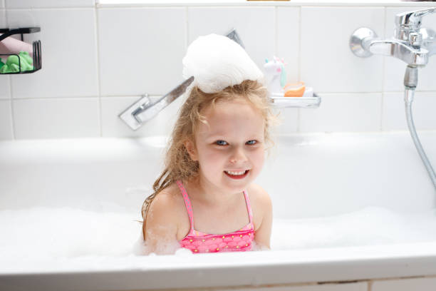 a happy little girl in a foam bath.