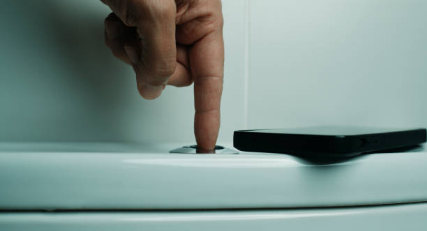 istock smartphone and man flushing the toilet 2170054845