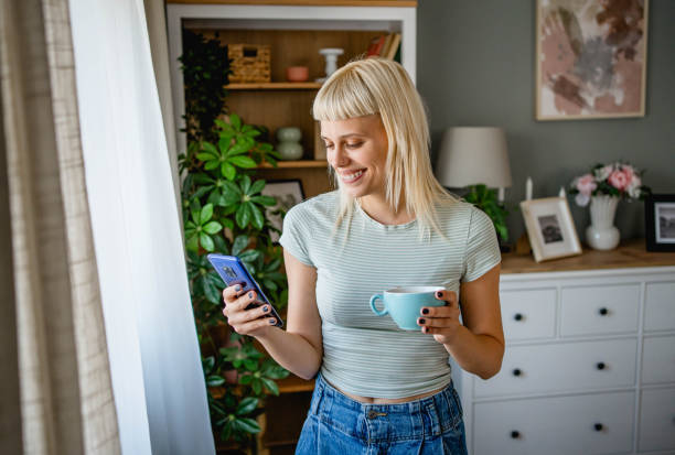 istock Woman drinking coffee and using a mobile phone 2170057317